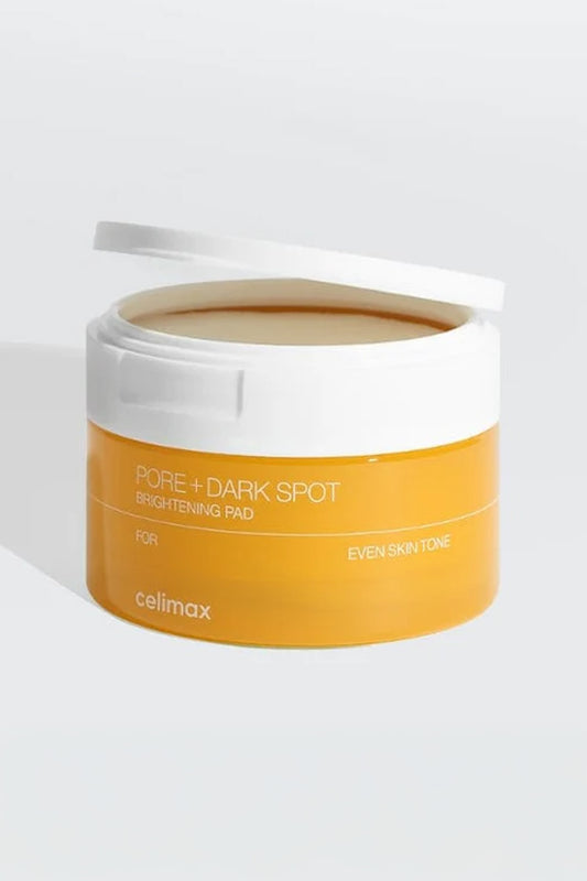 Pote amarelo Celimax Pore + Dark Spot aberto, com discos de algodão embebidos visíveis, sobre fundo claro